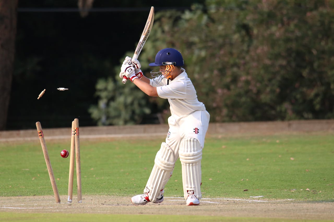 Young cricket player in focused action on the field. Capturing the moment of impact.